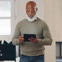 Man standing holding a tablet